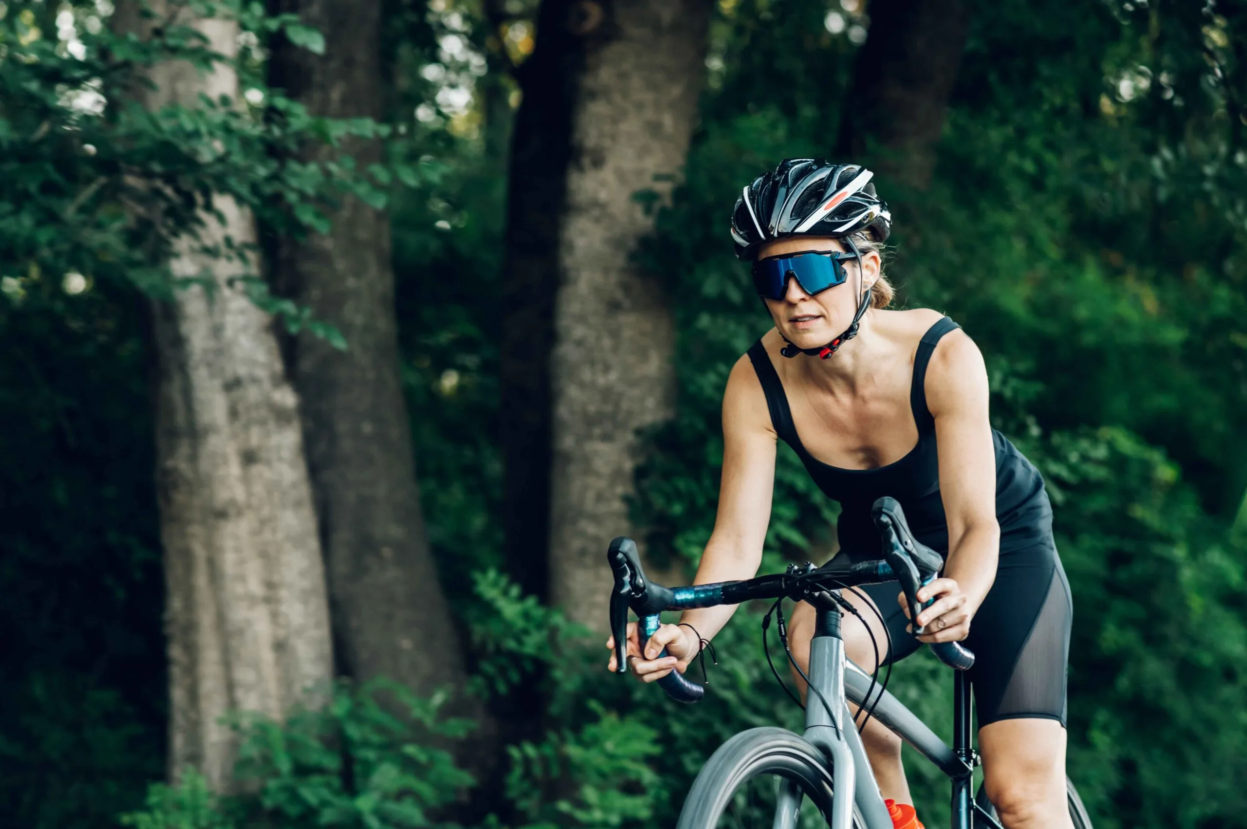 Athlete cycling outdoors in a mountain landscape.